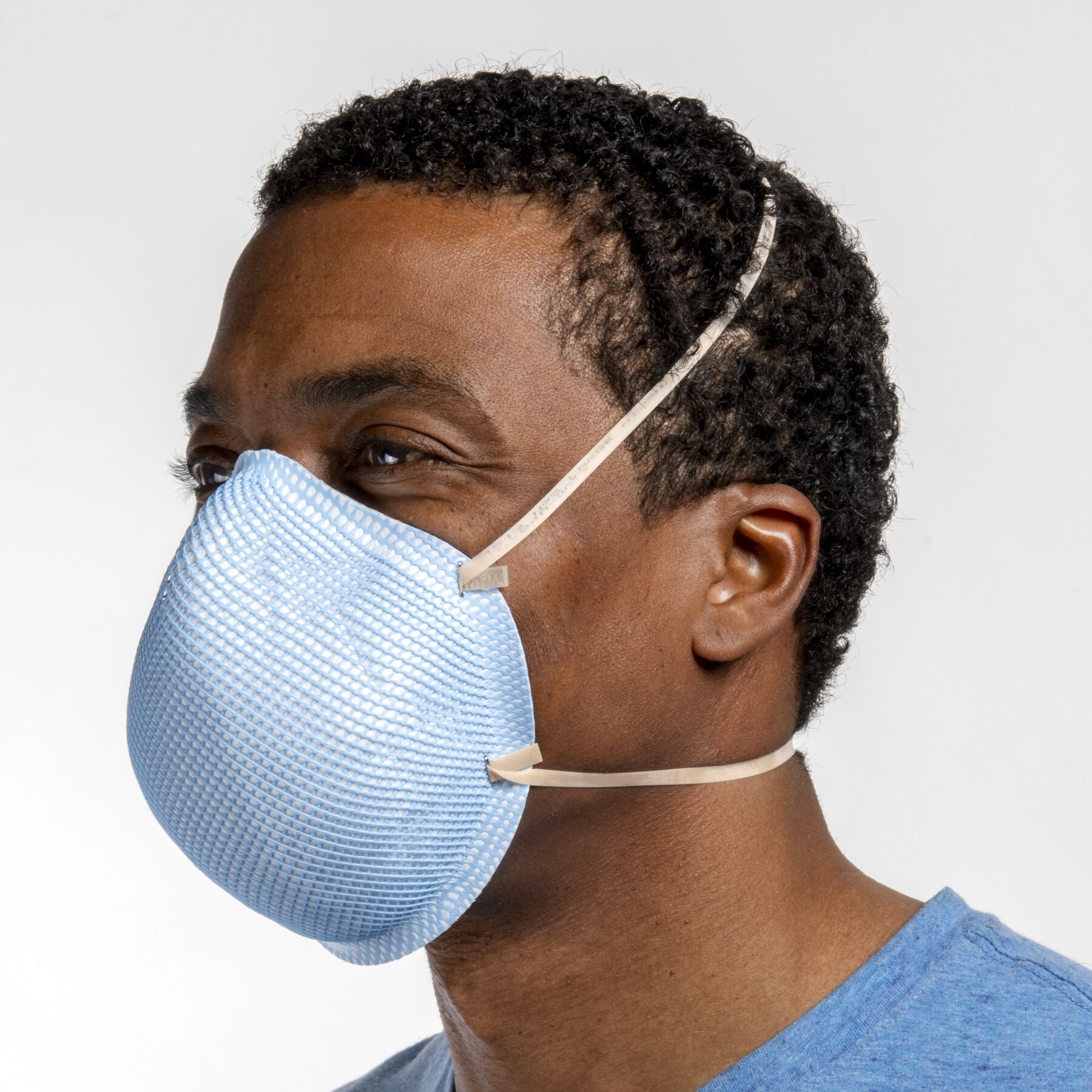 Man healthcare worker wearing large blue health care NIOSH N95 surgical respirator from Canada Strong Masks.